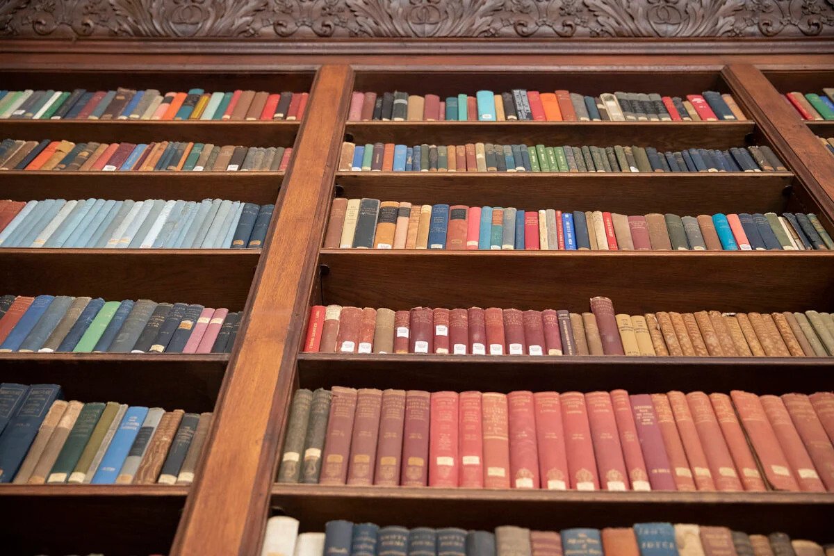 Photo of books in a library shelf.